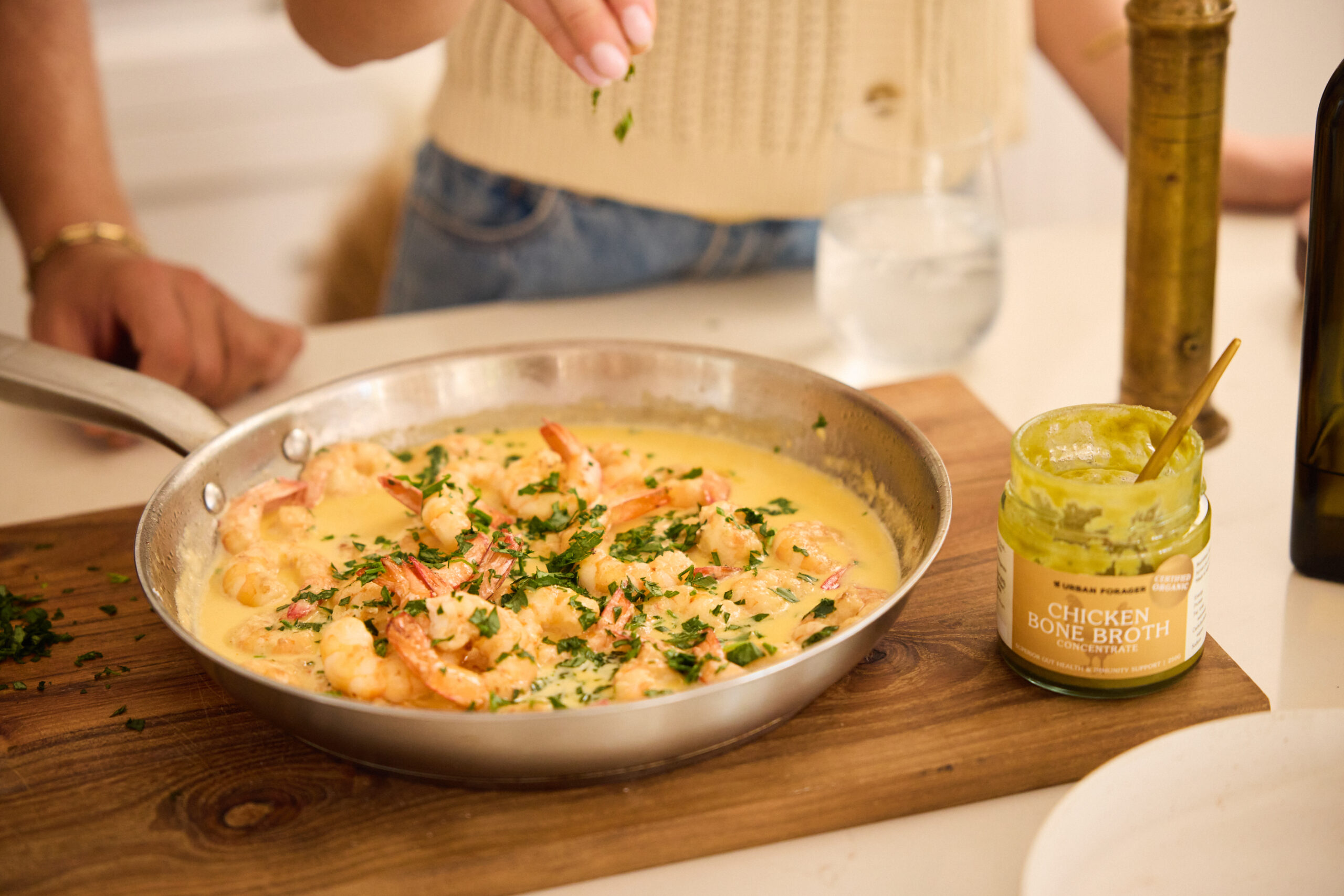 creamy garlic prawns in saucepan on chopping board, made with chicken bone broth concentrate